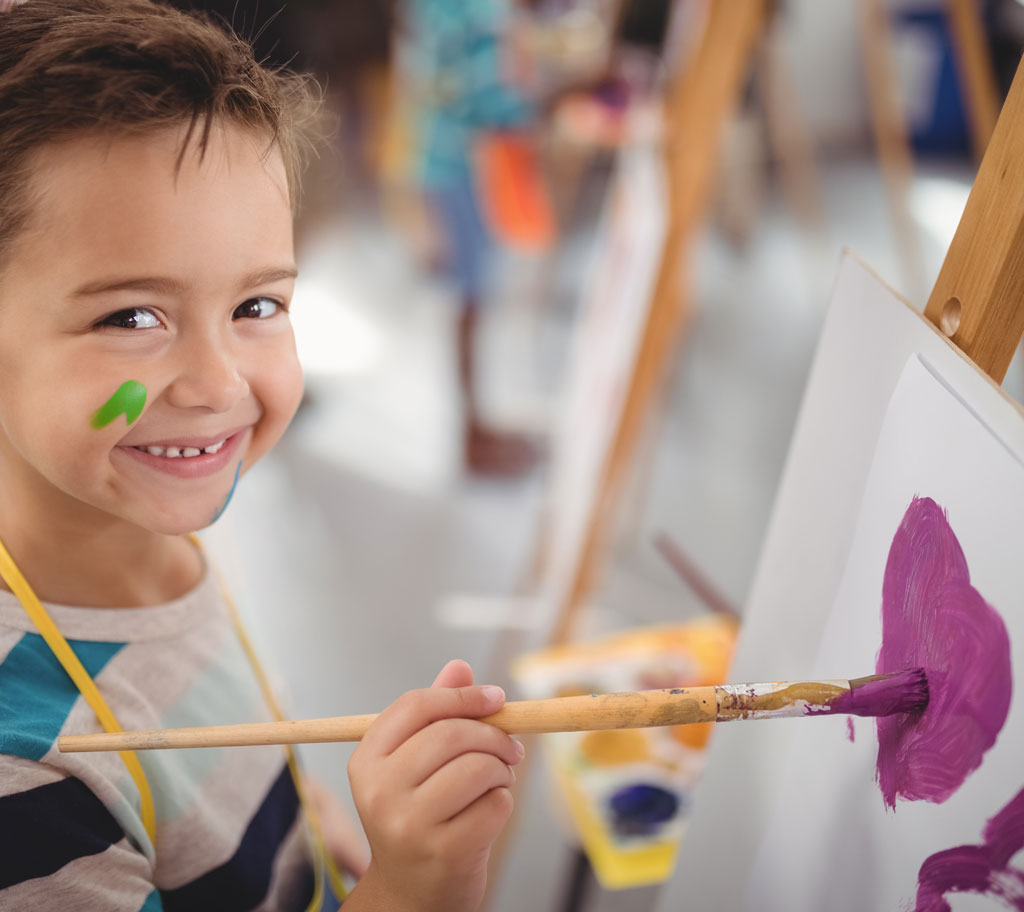 child painting at easel