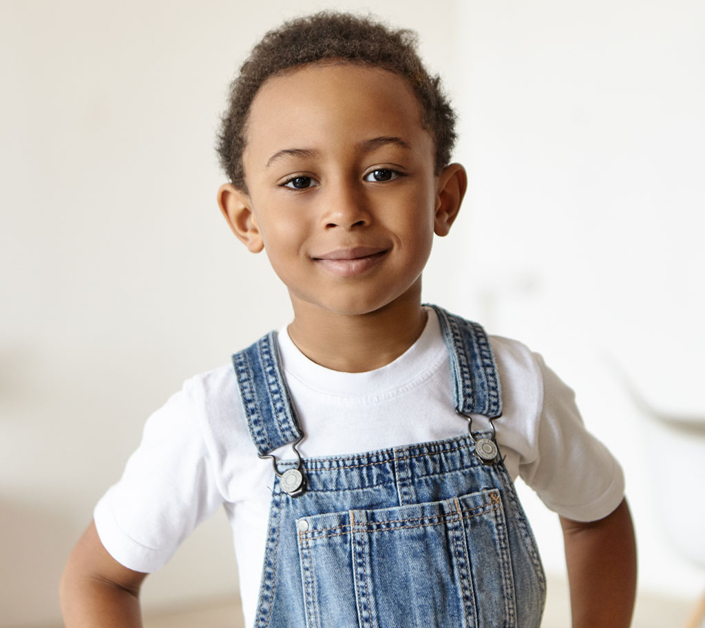 child wearing denim overalls