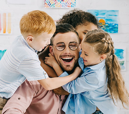 children hugging teacher