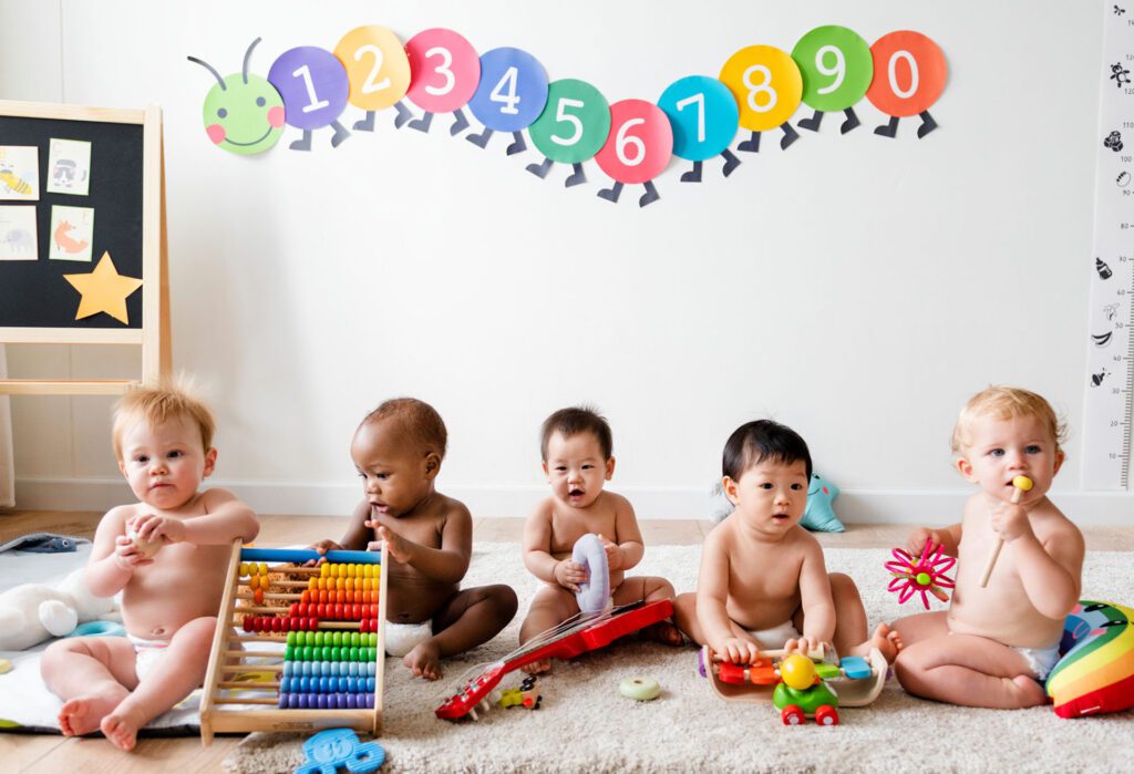 diverse babies paying with classroom toys