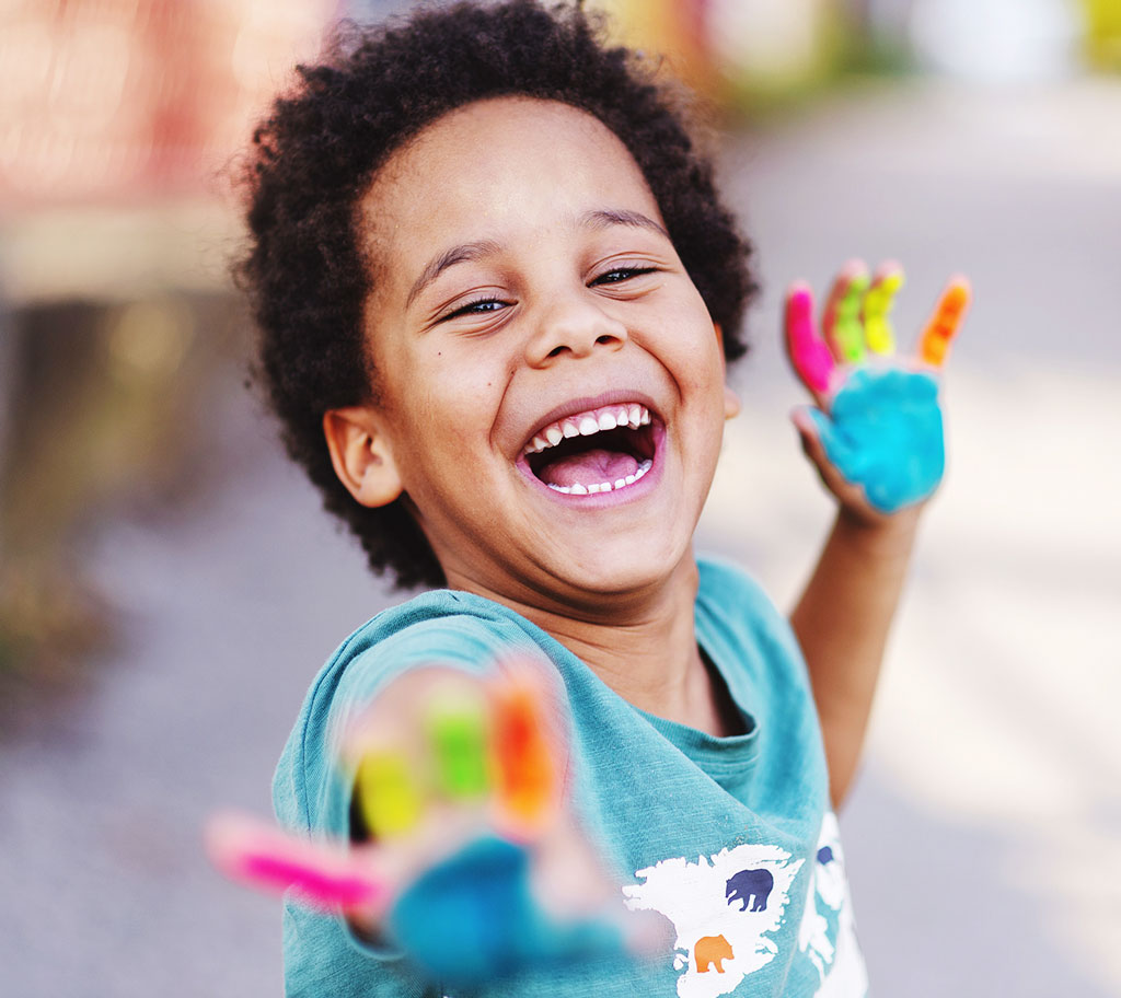 happy child with paint on hands