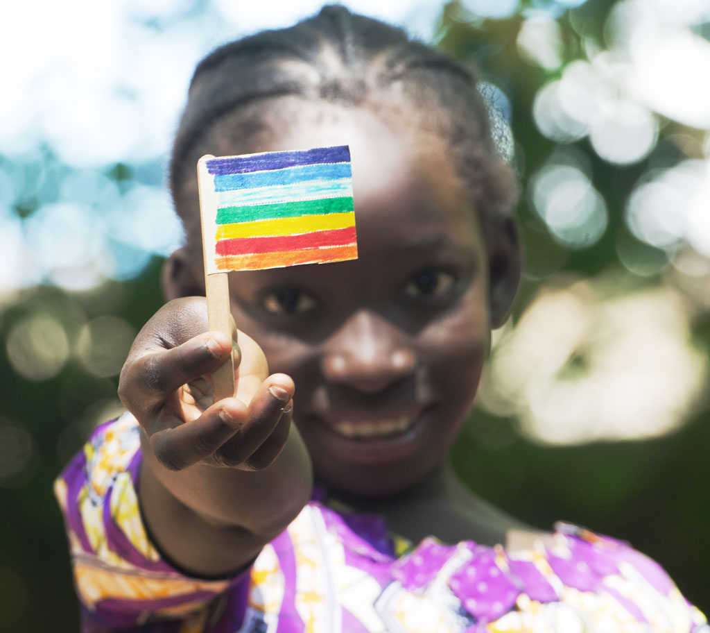 child holding homemade pride flag