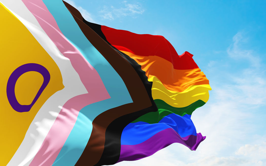 Pride Progress flag on sky background