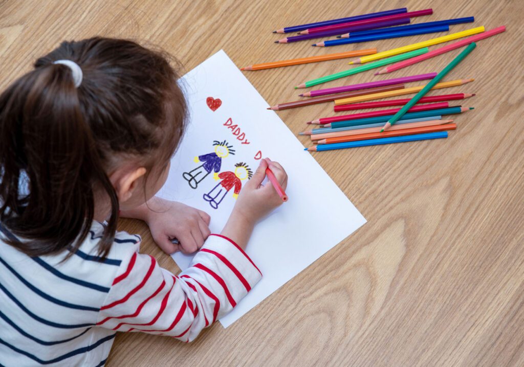 child draws picture of two dads