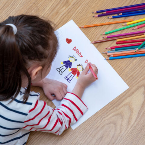 child draws picture of two dads