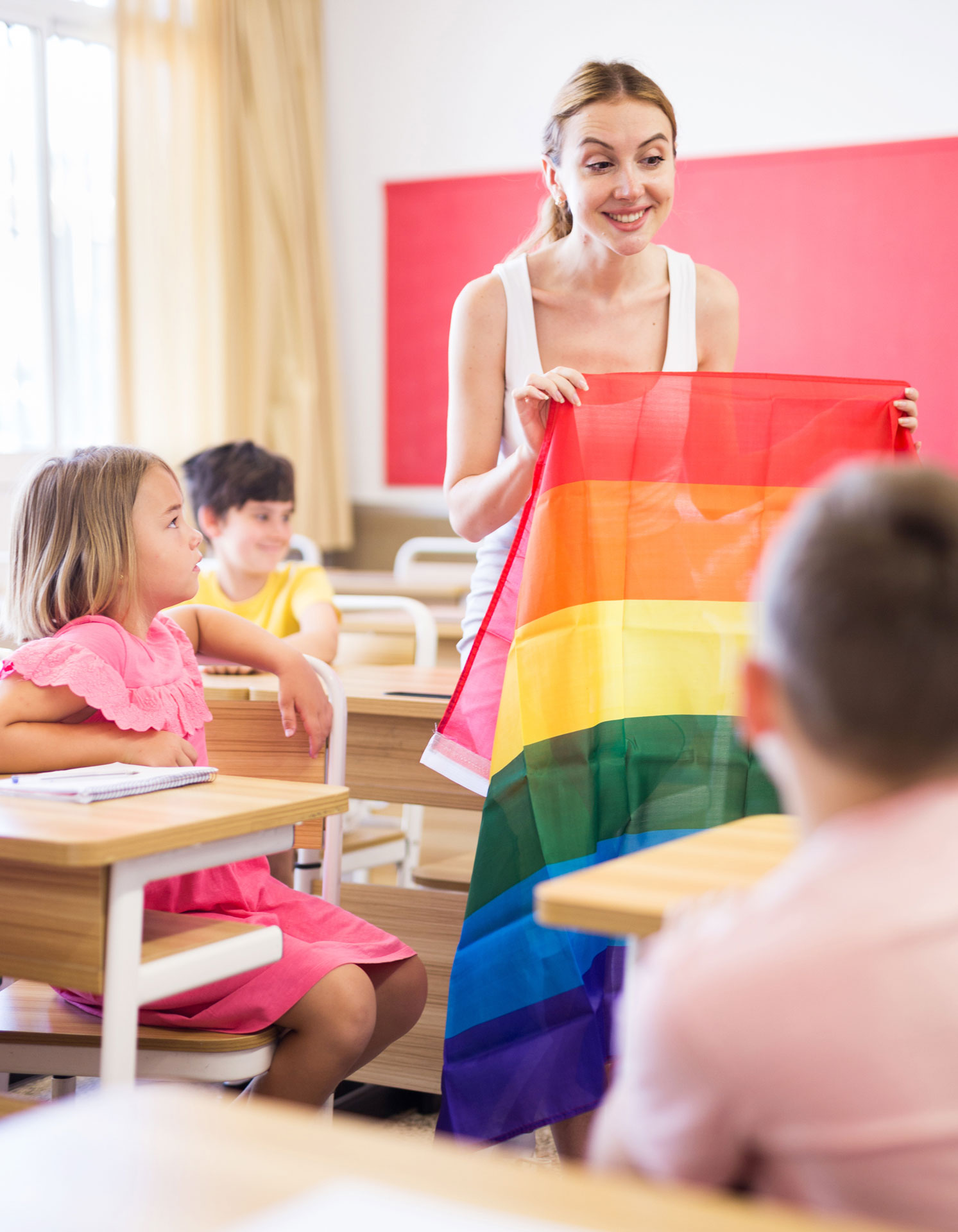 Teacher talking with kids about pride flag