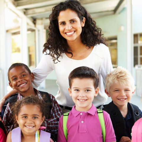 teacher and children looking at camera