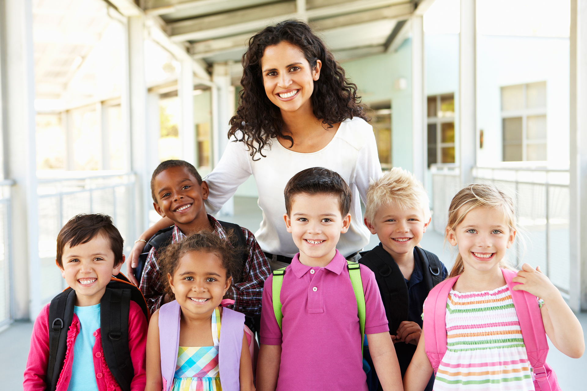 teacher and children looking at camera