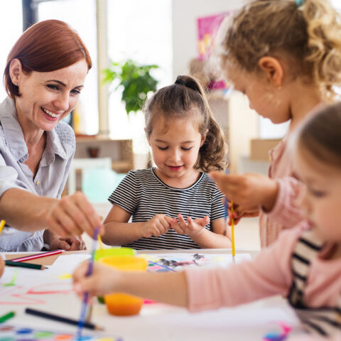 teacher and children painting