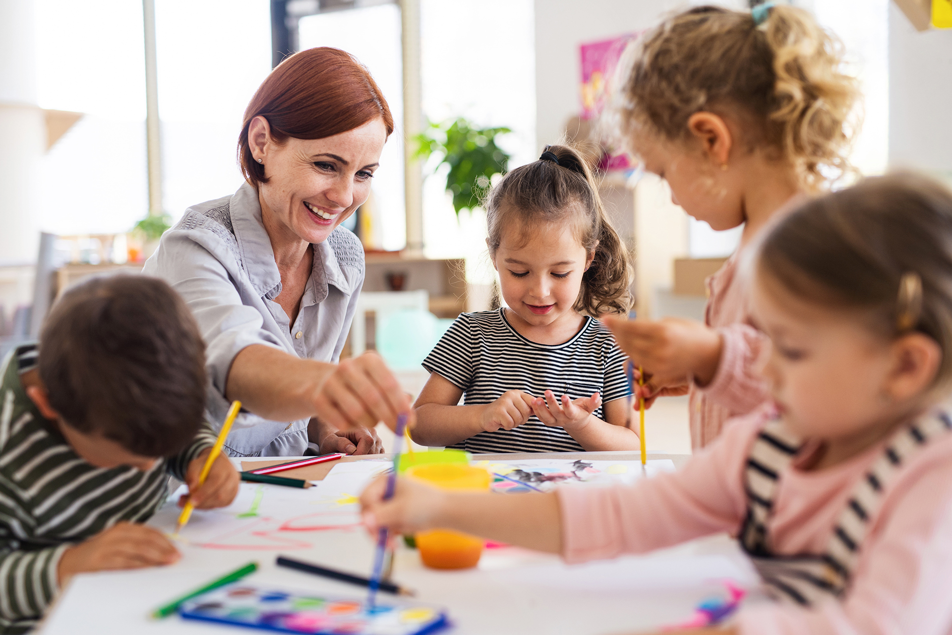 teacher and children painting