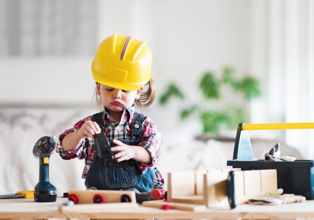 child role-plays with construction tools