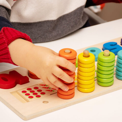 child with counting toy