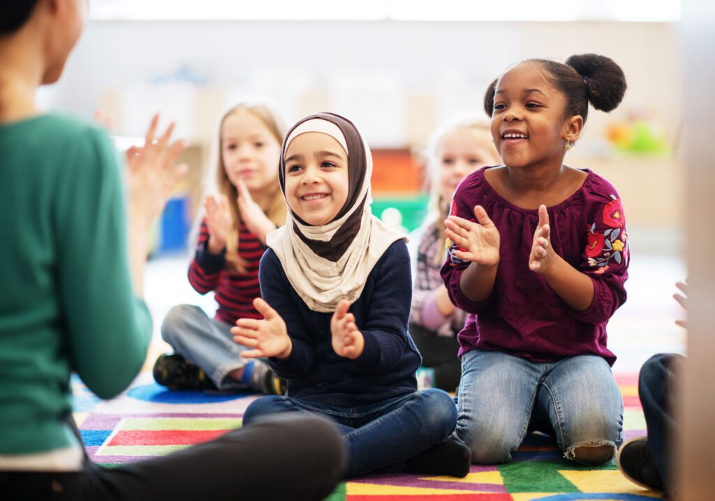 diverse children clapping