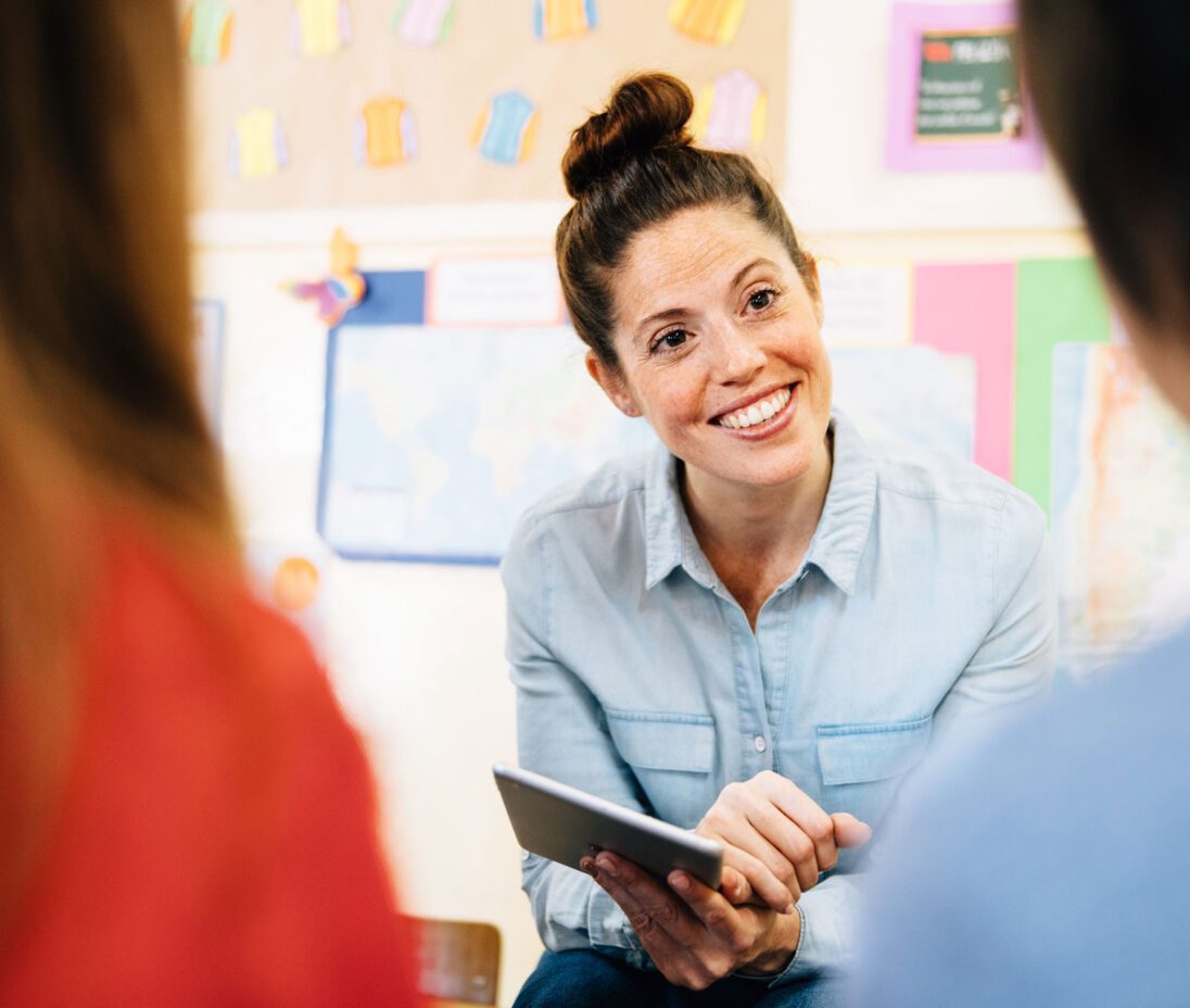 happy teacher speaks with children