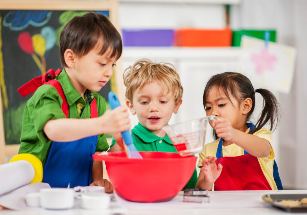 three children engaging in cooking play